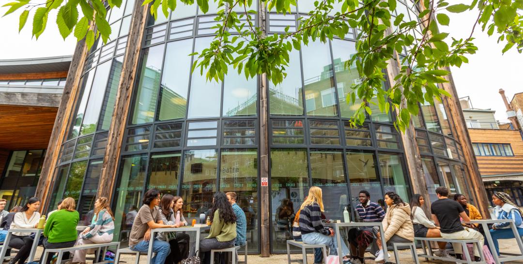 Students sitting outside a Durham University campus building