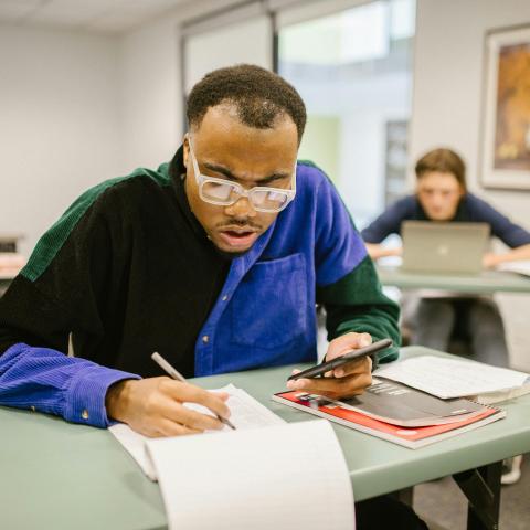 A mature student working in a classroom