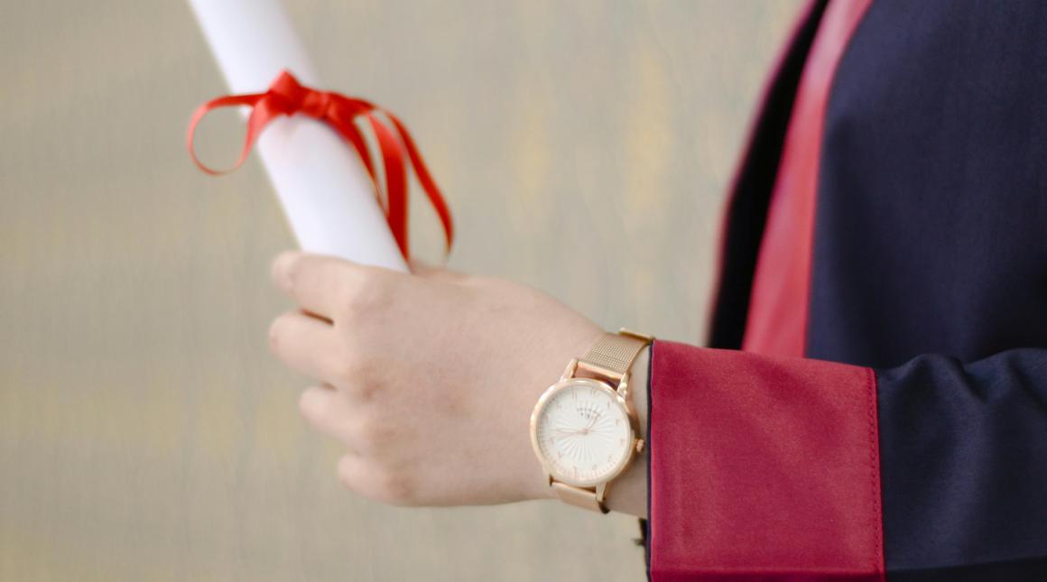 Person Holding Diploma