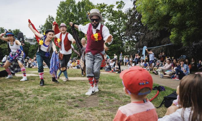 Performers dance outside on the grass at a Turner Sims Southampton family day 