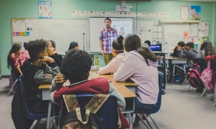 A teacher leads a secondary school class