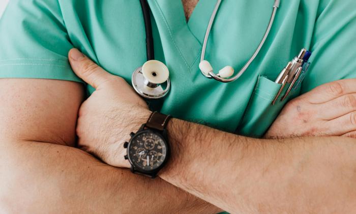 Crop unrecognizable doctor with stethoscope