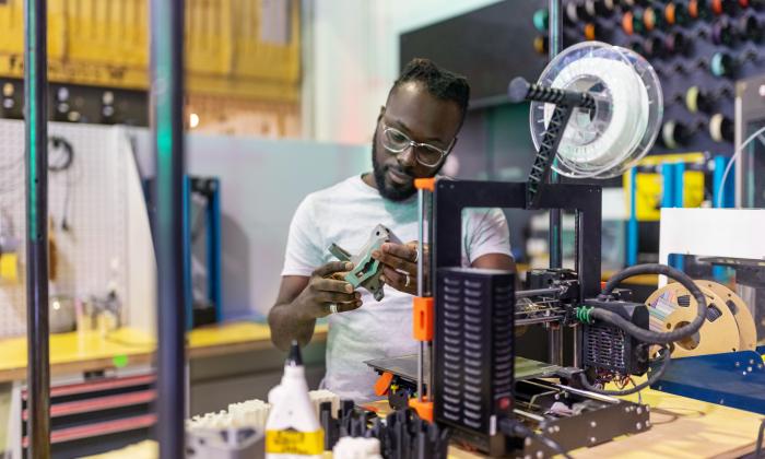 Researcher working with a 3D printer