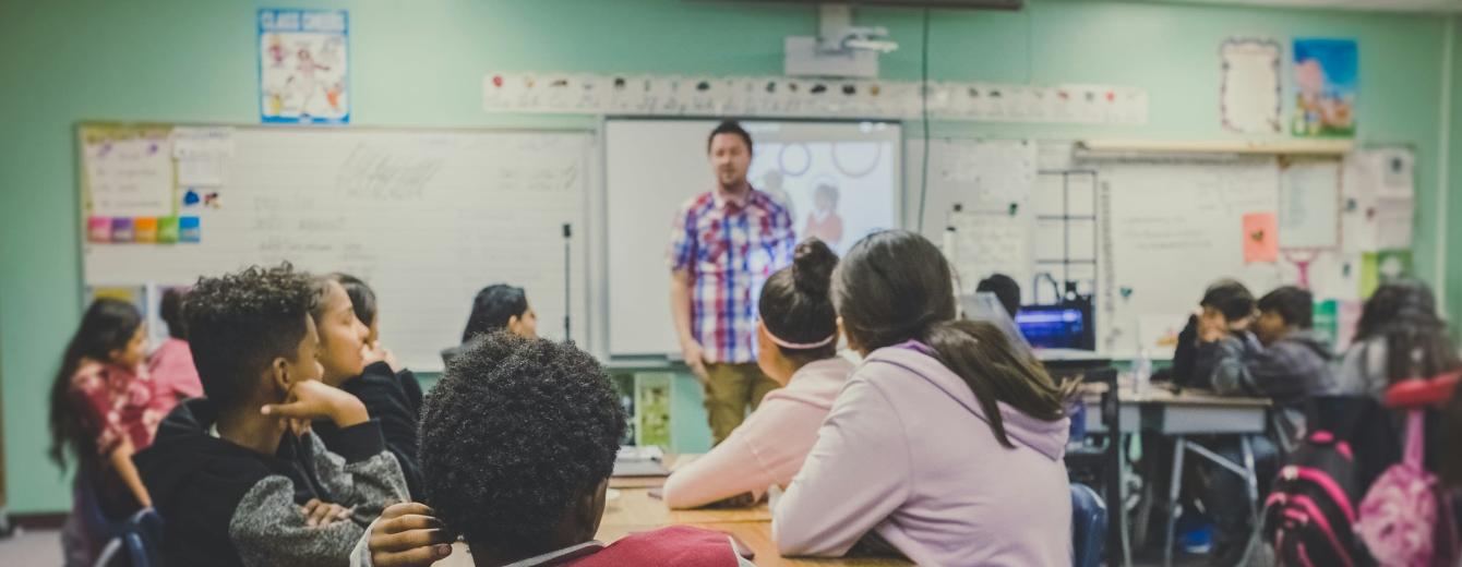 A teacher leads a secondary school class