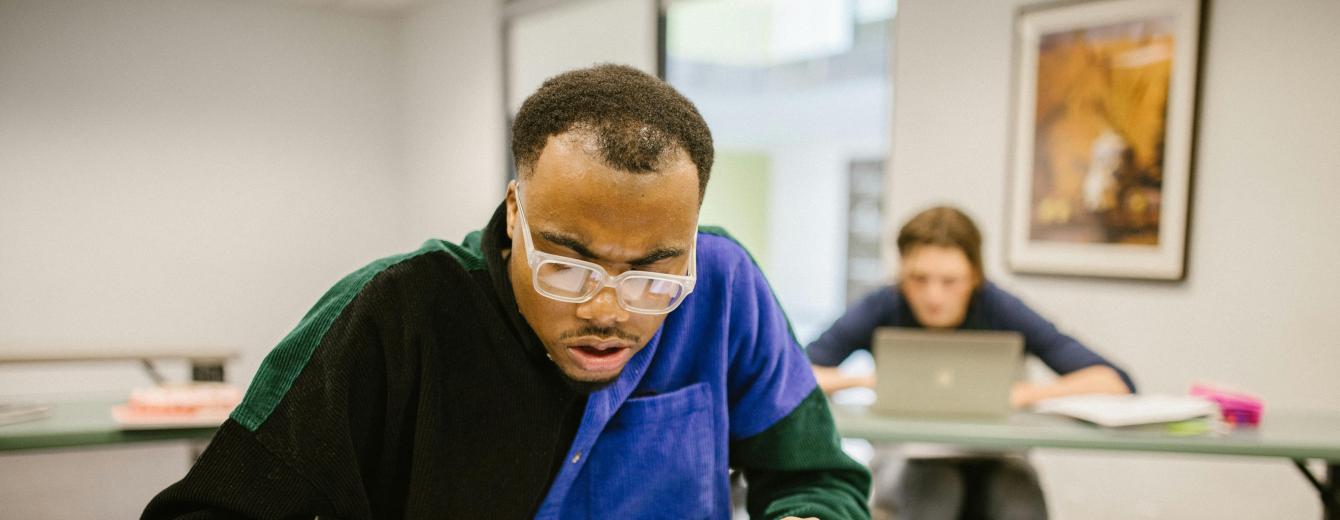 A mature student working in a classroom